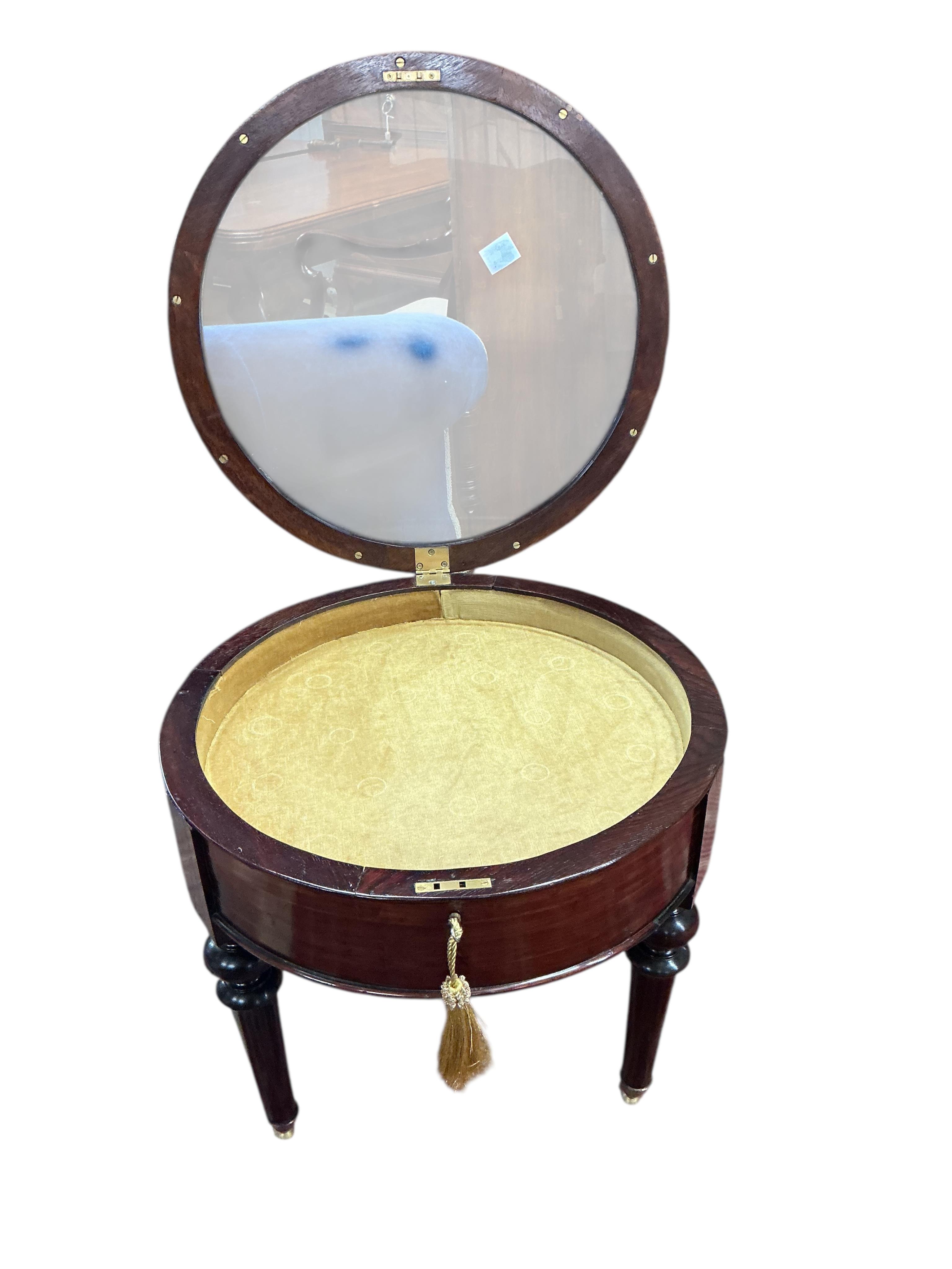 A Victorian style circular mahogany low bijouterie table, diameter 60cm, height 58cm